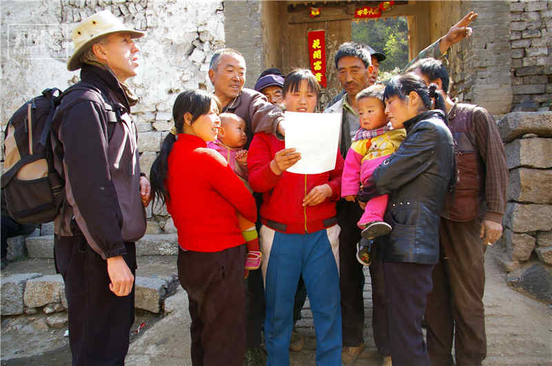 今昔长城对比的新的旅程就这样开始了，威廉·林赛得到了沿线很多村民、老人、学者、摄影师的支持，也打听到很多关于长城的故事和遭遇。这些长城，除了被开发成旅游景点之外，多数在自然或人为的侵蚀下，在时光中慢慢破裂、垮塌，有的只剩下一个土墩子，有的直接消失了……图为威廉在河北涞源向老乡打听老照片的拍摄地点。朴铁军 摄